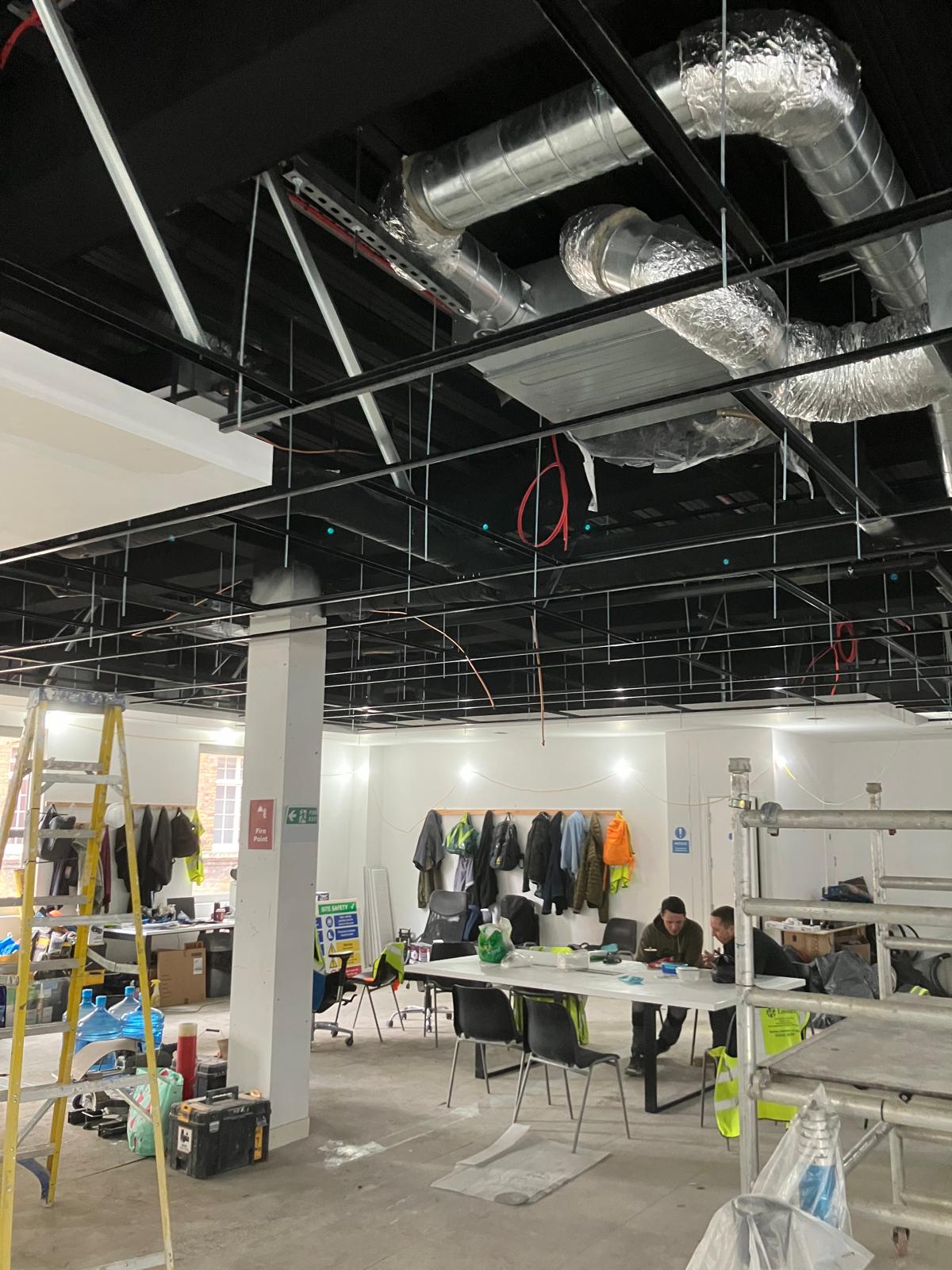 Open plan workspace with exposed ceiling services